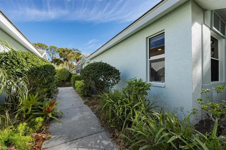 Entry to the home lushly landscaped with tropical foliage providing privacy from neighbors.