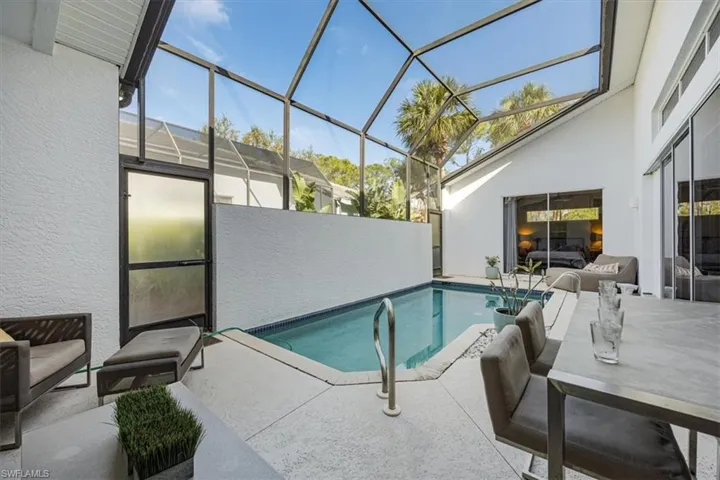 Screened lanai with private views of tropical landscape and open air space.