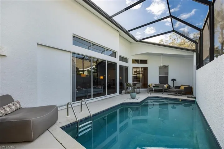 Villa outdoor private pool featuring an outdoor living space, a lanai, and a patio