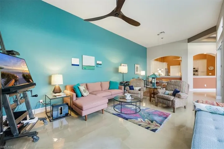 Living room perfect for entertaining and open to outdoor private living space with pool