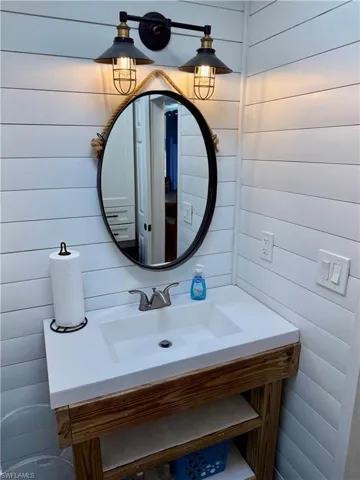 Bathroom featuring vanity and wooden walls