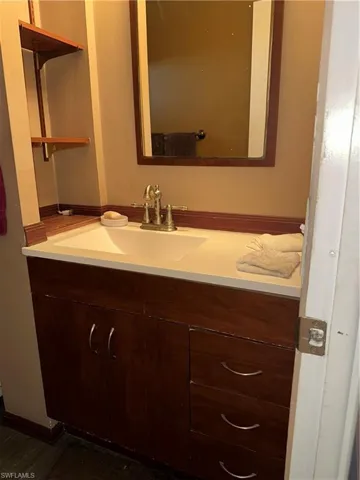 Bathroom with vanity and dark wood-style floors