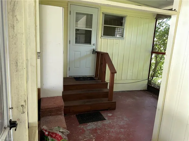 Property entrance featuring board and batten siding