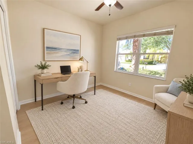 Wood-finish flooring, ceiling fan, and a large window with natural light