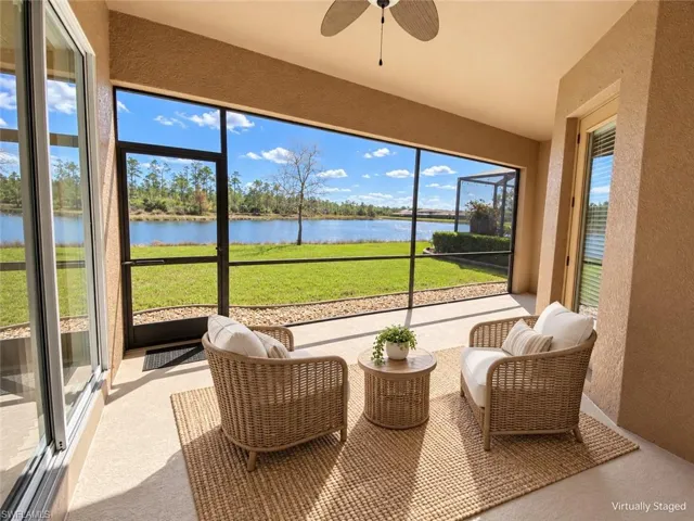 Screened patio featuring a ceiling fan, sliding glass door access, textured wall finish, and direct water frontage