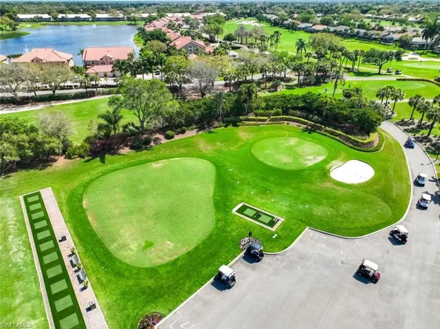 Aerial perspective of suburban area with a golf course and a nearby body of water