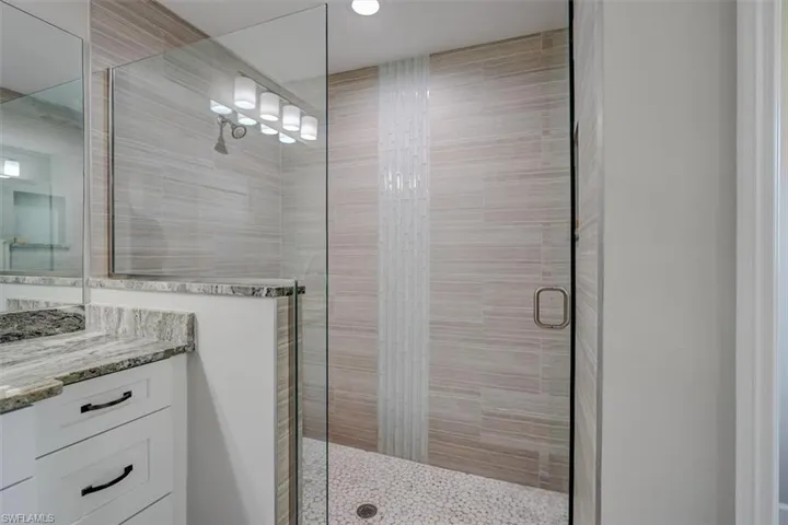 Bathroom with vanity and an enclosed shower