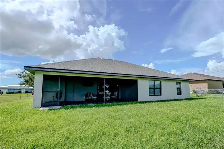 Rear view of property featuring a lawn