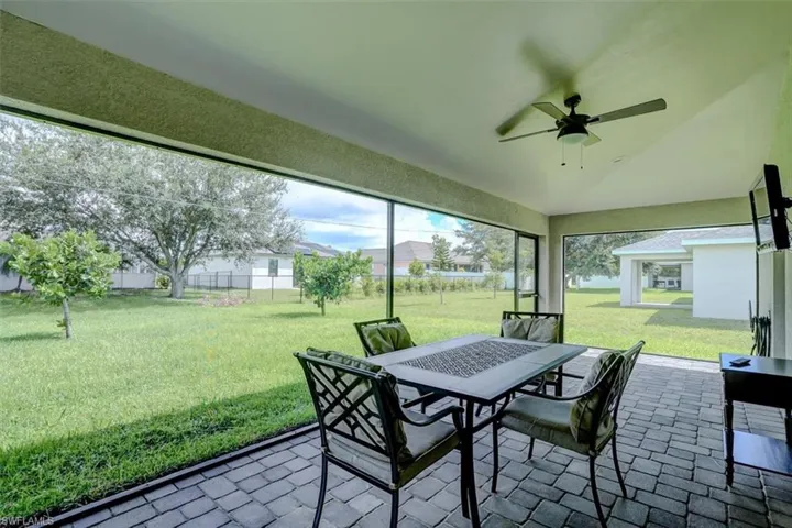 Sunroom featuring lofted ceiling and ceiling fan