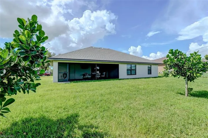 Back of house featuring a lawn