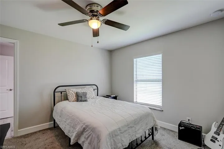 Bedroom featuring ceiling fan and carpet floors