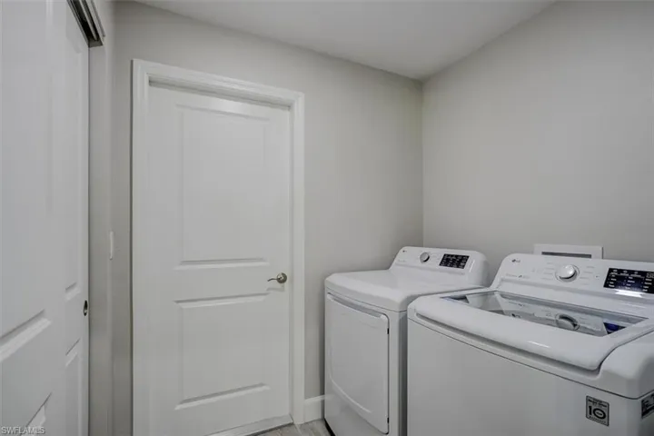 Clothes washing area featuring separate washer and dryer