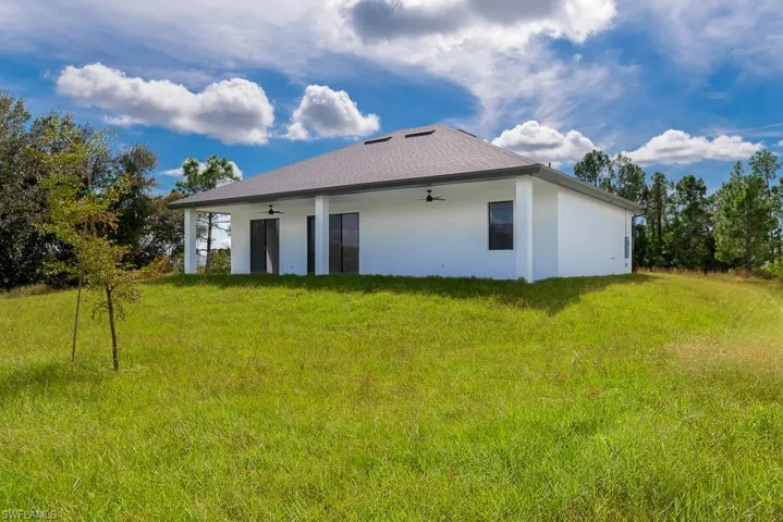 Rear view of house with a lawn