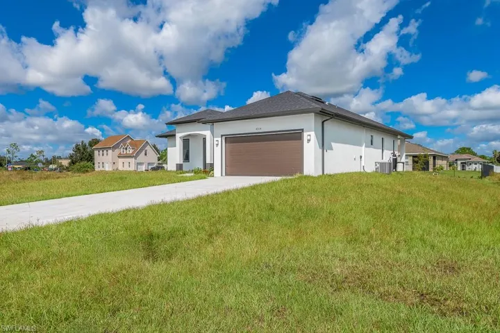 View of front of house with a front yard and a garage