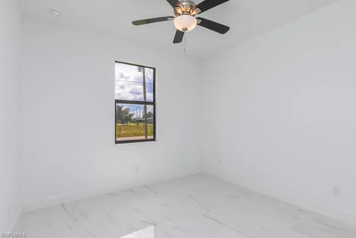 Spare room with ceiling fan