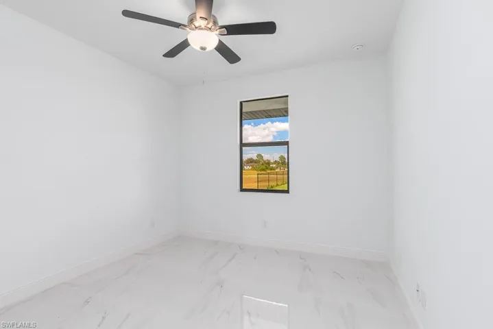 Unfurnished room featuring ceiling fan