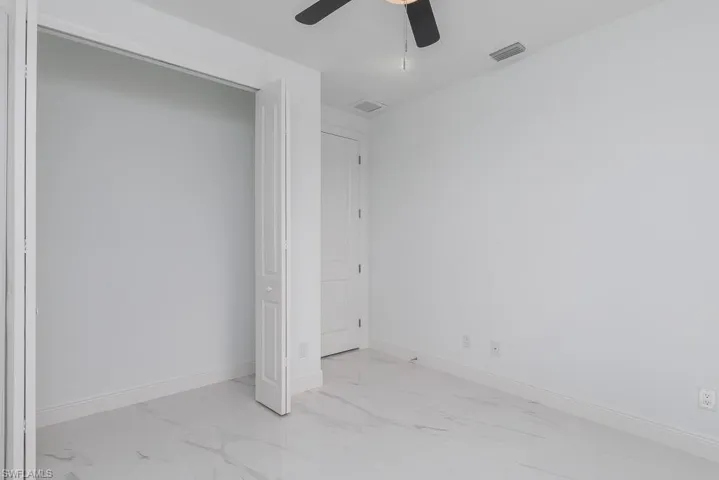 Unfurnished bedroom with ceiling fan