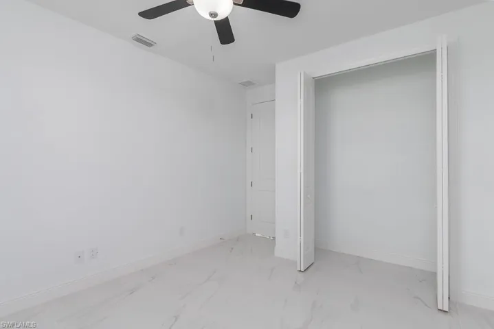 Unfurnished bedroom featuring ceiling fan and a closet