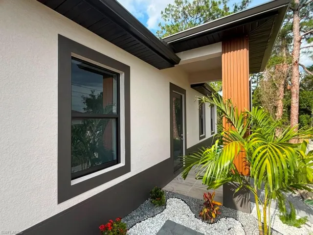 Contemporary exterior featuring white stucco and dark trim