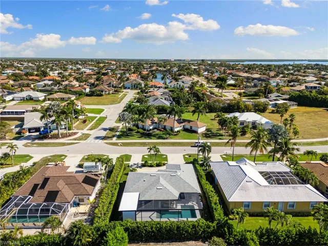 Aerial perspective of suburban area with a nearby body of water