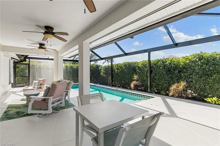 Outdoor pool with a lanai, a sunroom, and a patio area