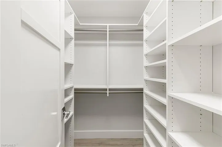 Walk in closet featuring light wood-style flooring