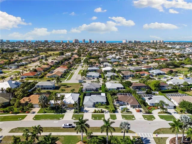 Aerial view of residential area featuring skyline and a large body of water