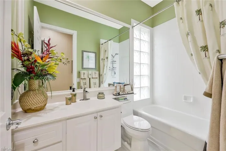Full bathroom featuring plenty of natural light, oversized vanity, toilet, and shower / tub combo
