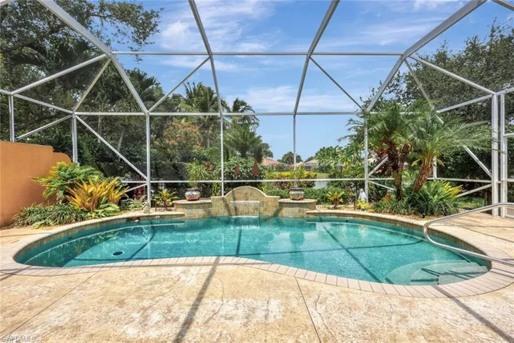 View of swimming pool with a patio and glass enclosure
