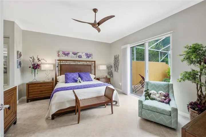 Bedroom with ceiling fan, light tile floors, ornamental molding, and access to exterior