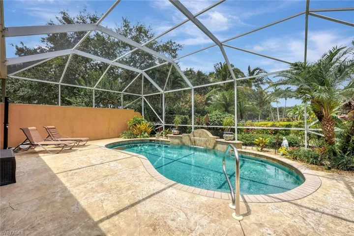 View of swimming pool with a patio area and glass enclosure