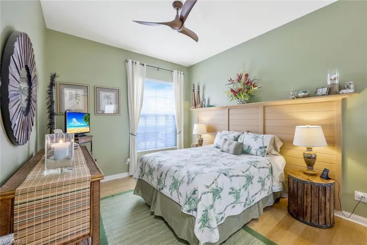 Bedroom with ceiling fan and hardwood / wood-style floors