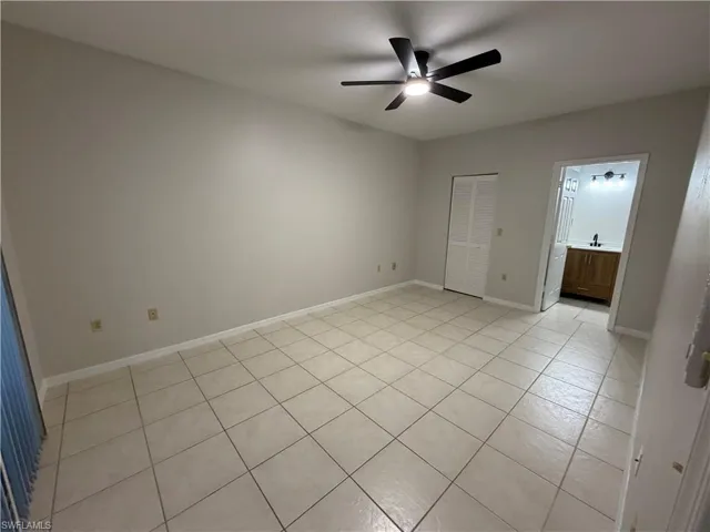 Kitchen featuring a peninsula, white cabinets, white appliances, light tile patterned flooring, and decorative backsplash
