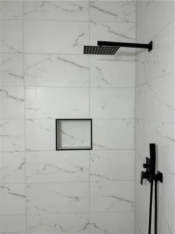 Unfurnished bedroom featuring a closet, a ceiling fan, and light tile patterned flooring