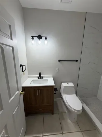 Unfurnished bedroom with a closet, light tile patterned floors, and ceiling fan
