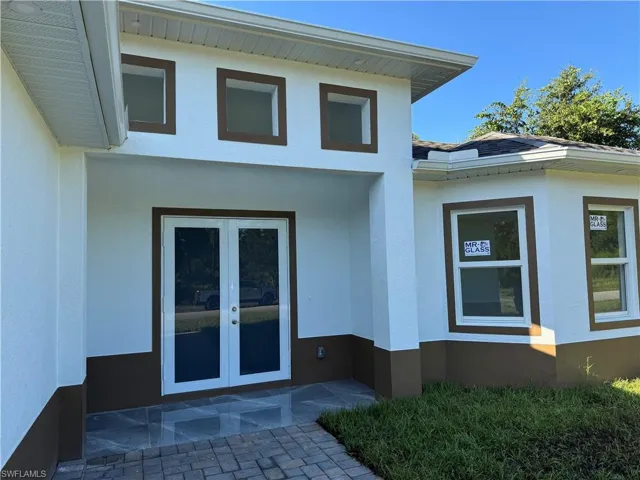 View of exterior entry featuring french doors