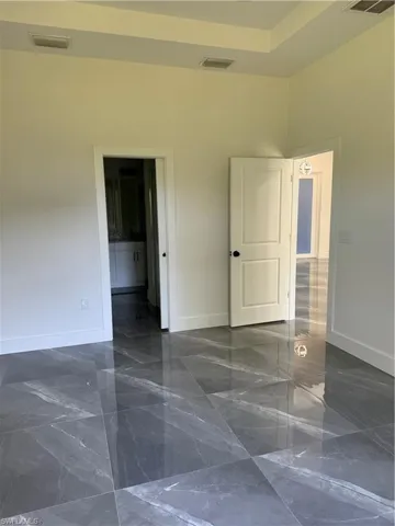 Tiled empty room with a towering ceiling