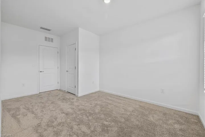 Spare room with carpet floors and baseboards