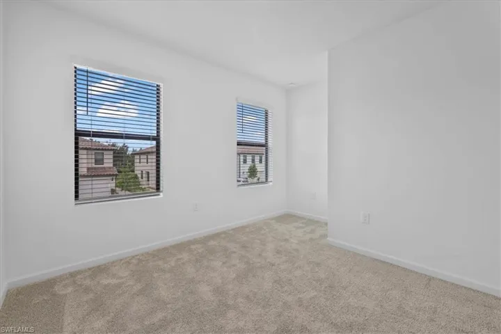 Carpeted spare room with baseboards