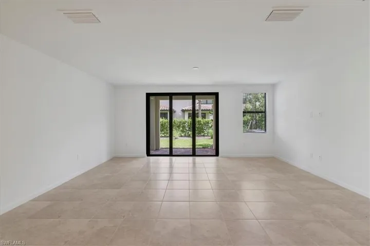 Spare room with light tile patterned floors and baseboards