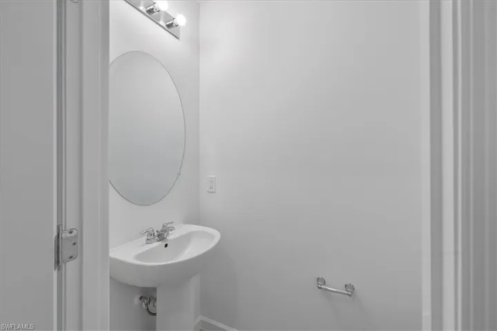 Bathroom featuring baseboards and a sink