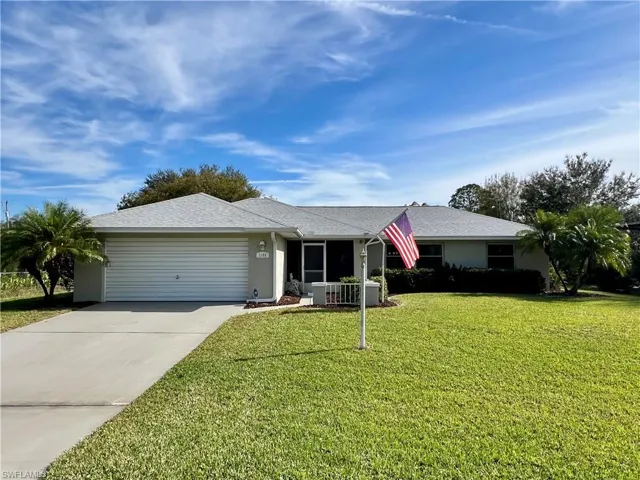 Single story home with garage, and a front yard