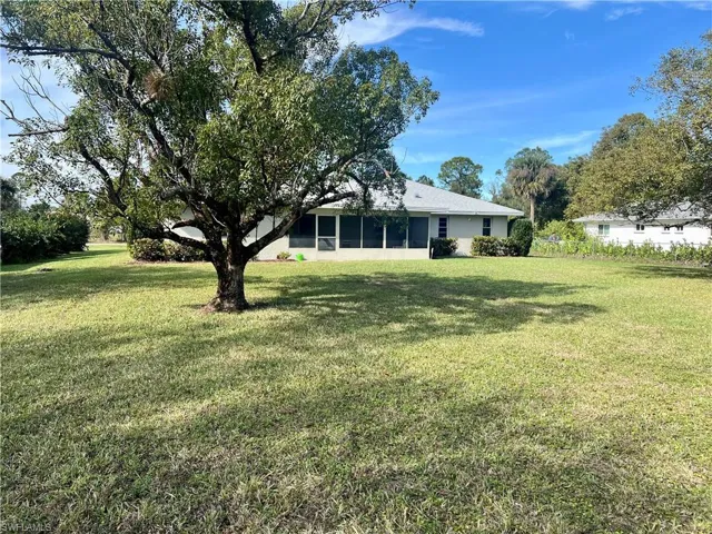 View of yard with a sunroom