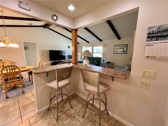 Kitchen with GRANITE TOPS ON BREAKFAST BAR