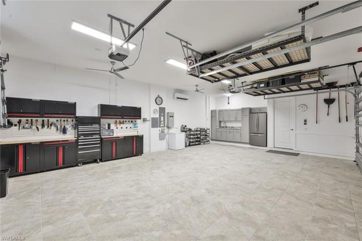 3 Car Garage air conditioned, tiled floor, full workshop (minus tools) stays, chest freezer and mini kitchen with full size frig, cupboards and 2 4x8 storage racks. Gas powered automatic 22KW Generac Emergency Generator and dual ceiling fans with LED lites.