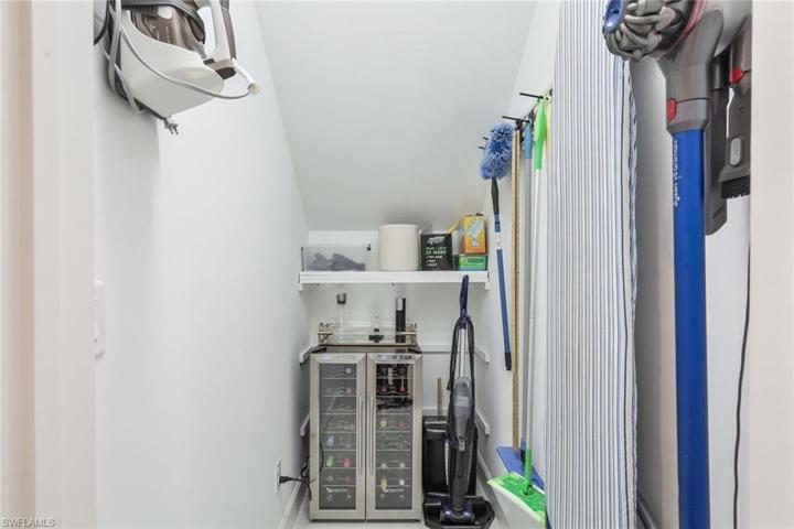 Under stairs storage with wine cooler.