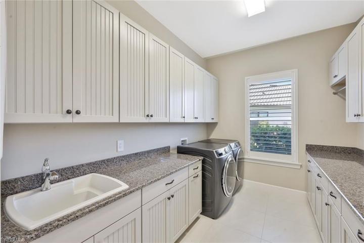 Amazing laundry room with lots of counter and hanging space