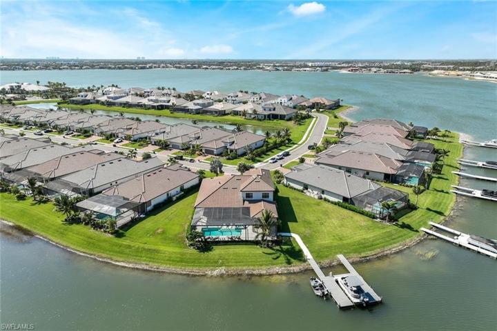 Aerial view showing boat dock and large freshwater lake just a few houses away where you can ski on the slalom ski courses, tube, fish wakeboard, paddle board etc.