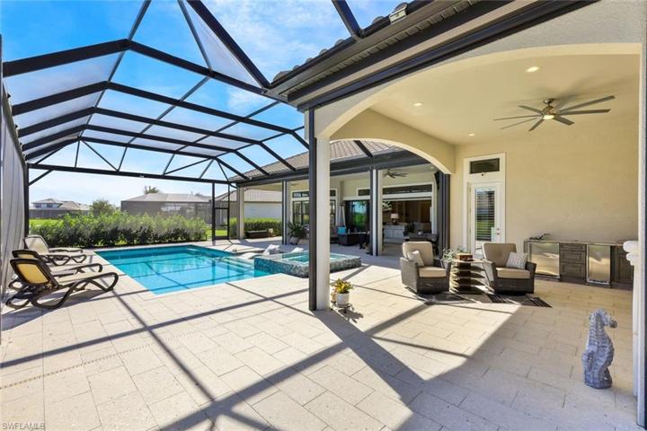View of pool spillover spa and part of two covered lanai areas.