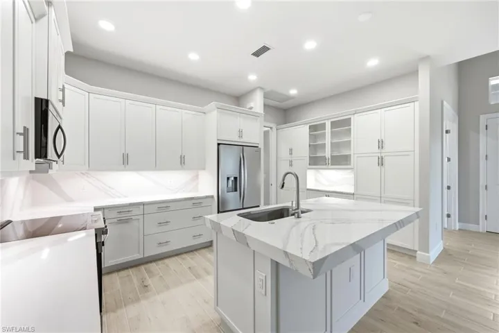 Upgraded spacious Kitchen with white cabinets and countertops